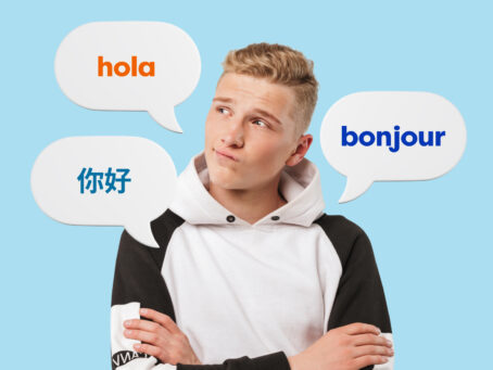 Boy on a light blue background, with three bubbles saying Hello in different languages