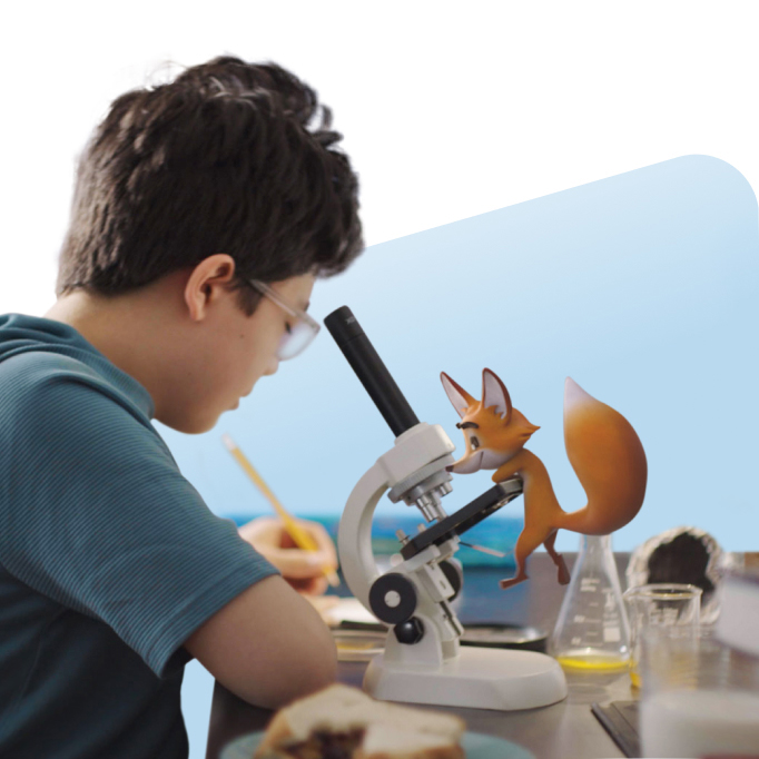 Boy with microscope and toy fox on microscope