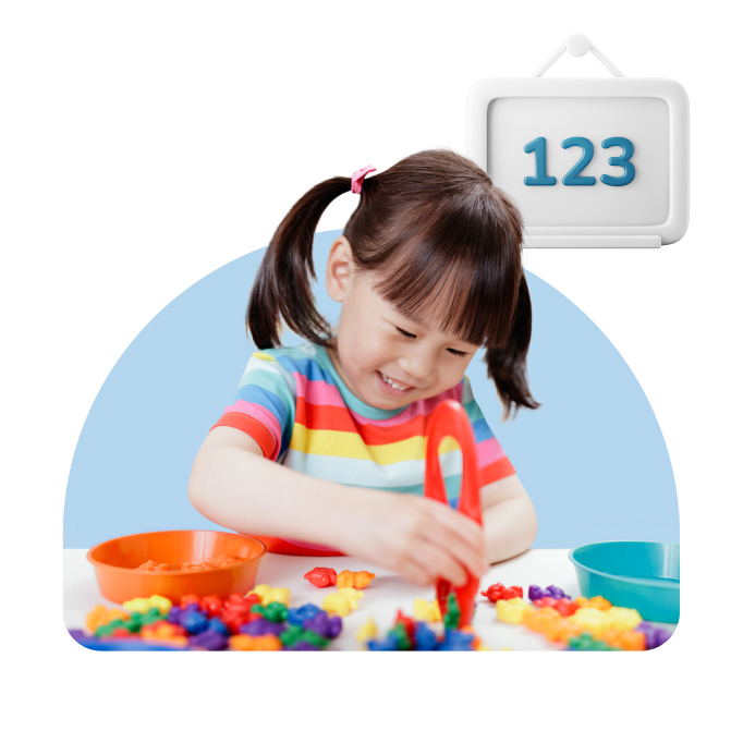 Little girl playing with colorful objects, board with numbers one, two, and three in top right corner